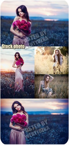      / Girls in a field with flowers - stock photo